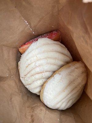 White concha and some bow shaped bread.