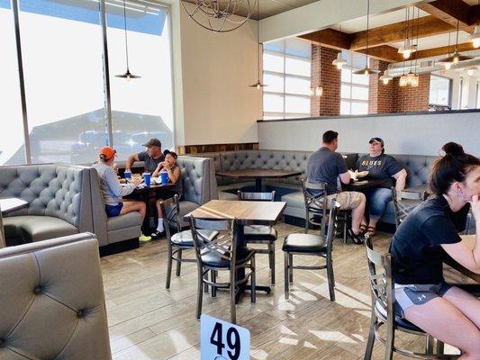 It is open seating inside of the restaurant. This is the seating area near Woodgrain Pizzeria.