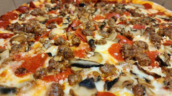 Pepperoni, Sausage, Garlic and Mushroom Pizza