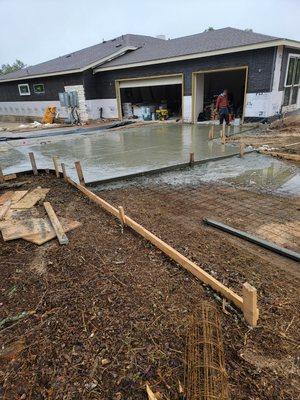 New home construction including concrete driveway.