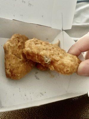 What is this NASTY hair ball attached to a chicken nugget????? This is gross!!!!!! Never eating here again!!!!!