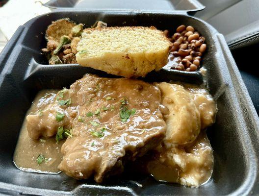 Smothered pork chop mashed potatoes, black-eyed peas, and corn, batter, squash, and okra