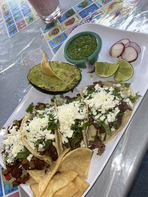 Spicy pork tacos (2 on the left), beef tacos (2 on the right), side of avocado