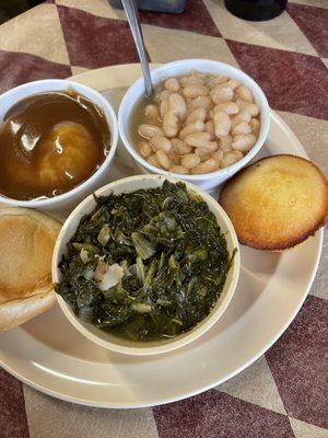 Vegetarian plate, 3 sides Green turnip, mashed potatoes with brown gravy, white beans, cornbread, and a piece of bread loaf .