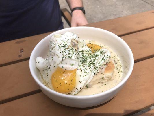 Biscuits and sausage gravy with sunny side up eggs