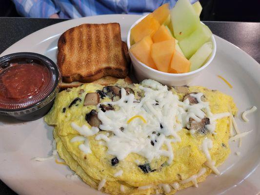 Omelete , fruit and gluten free toast.