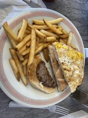 The world's smallest hamburger patty, overcooked egg, and cheese on a somewhat stale Kaiser roll.