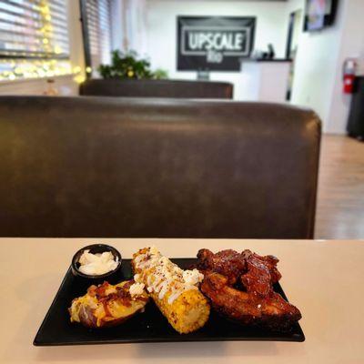 BBQ pork ribs, elote corn & baked potato.