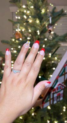 Red French tip manicure, real nails. Tips were slightly bigger to cover my nail line. Gold Christmas tree on ring finger.