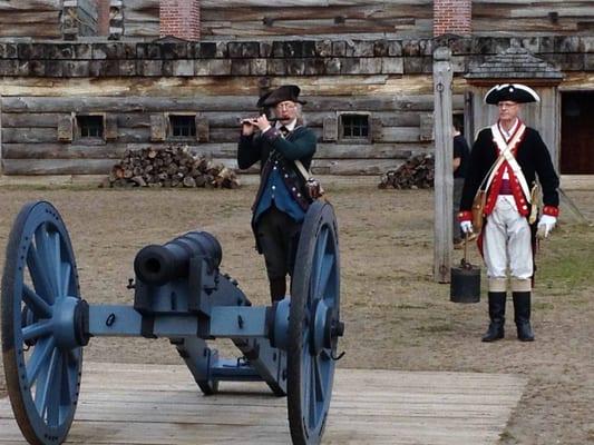 6 pound field gun "of last resort" in the parade ground with the reenactors being called to muster with a fife.