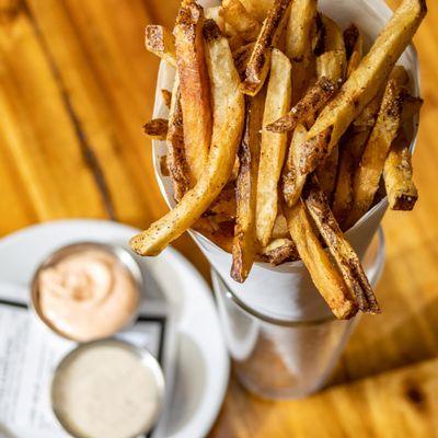 Duck Fat Fries: The ultimate indulgence!  Crispy perfection with Yum Yum & Roasted Garlic Herb dipping sauces.