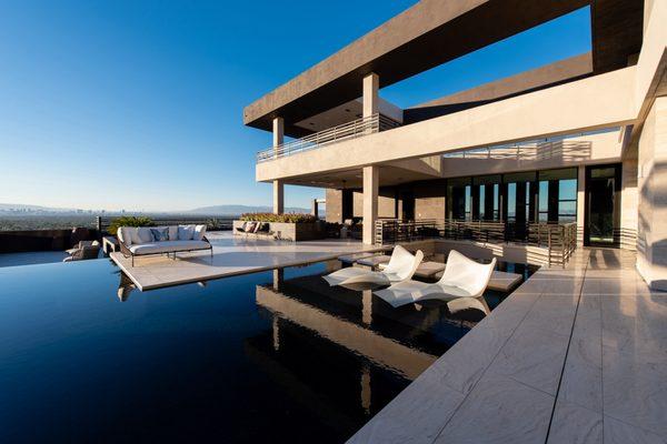 An alluring Las Vegas swimming pool with in water lounge chairs.