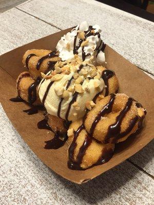 Donitas with ice cream, Mexican chocolate drizzle, topped with nuts and a side of whip cream.