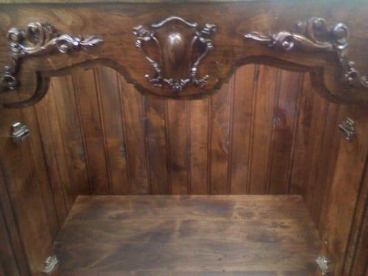 Carved solid walnut vanity in distressed walnut finish.