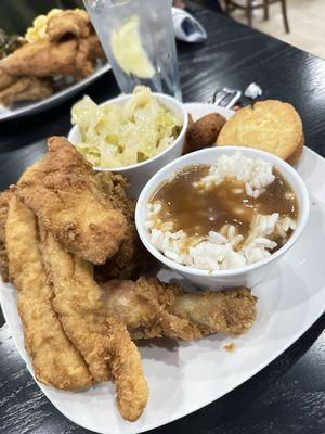 Fish and chicken with cabbage, rice and gravy and cornbread