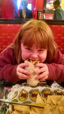 My daughter absolutely loving her burrito!