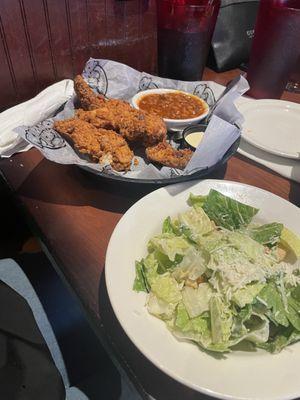 Chicken tenders and Caesar salad