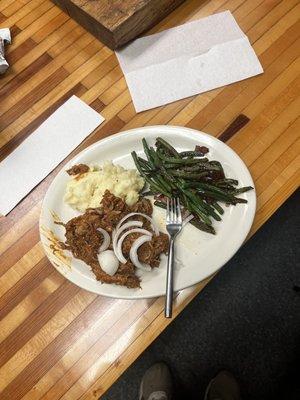 Boiled pork drowned in sauce. Mashed potatoes lacked flavor. I believe they were not drained. Tasted like water. That is all.