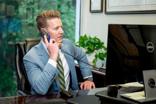 A Montlick Injury Attorney in his office speaking with a client.