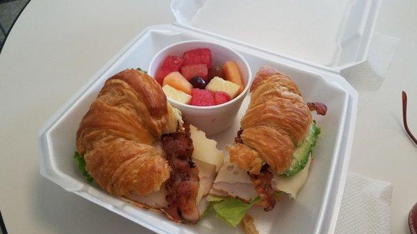 Classic club with avocado and bacon on a croissant