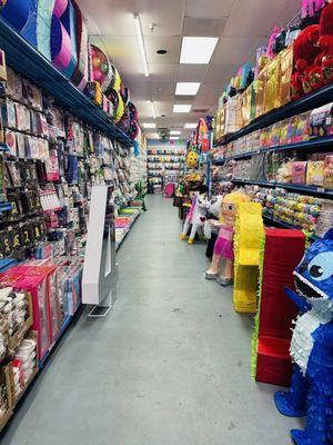 Party decorations aisle with piñatas.