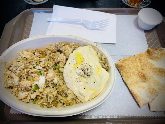 Chicken and rice dish with side of hummus