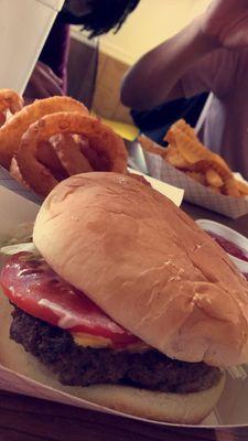 Homemade burger and crispy onion rings.