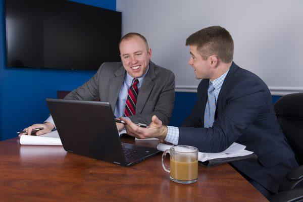 Founding Partners, Kevin and Tim, work on a client's case.