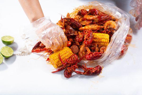 Crawfish, shrimp, corn, and sausage boil mix doused in Captain's Mix sauce