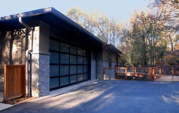 Oakton, VA; glass door garage; contemporary design; full exterior remodel; grey stone; cable rail; natural wood; screened porch