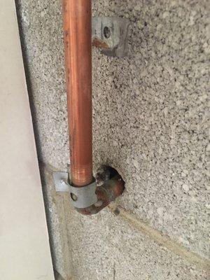 The original pipe ran up flat against the wall and was held by metal clamps. This pipe and spigot is not secure