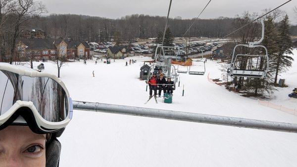 View down to the parking lot, main lodge, and lift to North Peak.