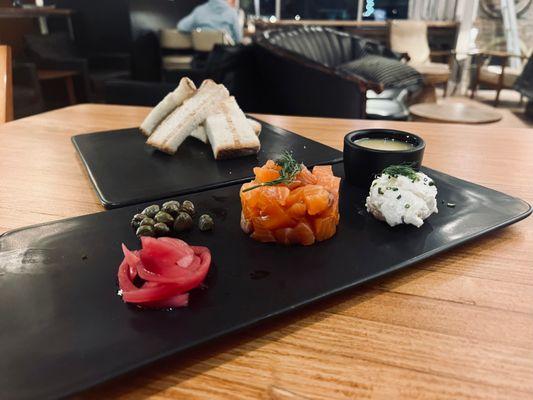 Gin cured salmon "tartare" paired with chive cheese spread, pickled onion and capers and grilled bread.  Fun starter to share with friends!