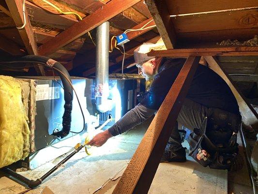 Checking the condensate drain pipe to make sure it is glued together in the attic.