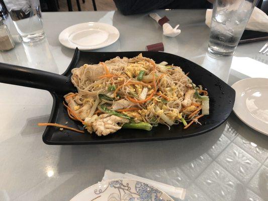 Stir fry chicken noodles served on a shovel. Delicious!!