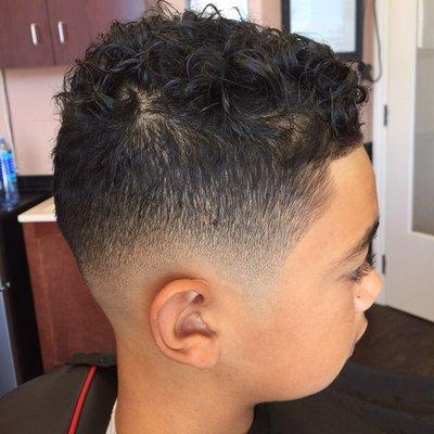 Low razor fade with curls and a razor line up.