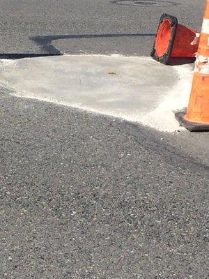 Meridian Greens Village - Manager: Denise R. - This is how TMT fixed a massive pothole, with concrete on an asphalt road.