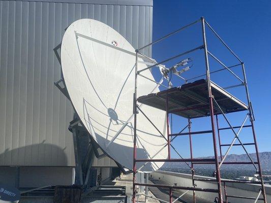 Portable scaffold set up to service a 10 meter satellite antenna.