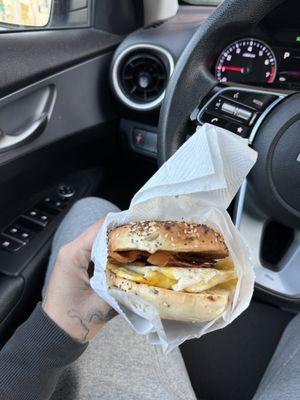 bagel with eggs, bacon, and ham