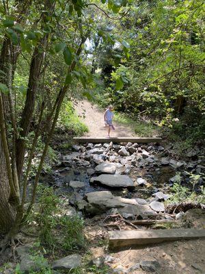 My daughter having fun crossing the water