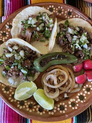 Handmade tortillas for your "street style" taco favorites served with limes, radishes, grilled onions and a grilled jalapeño