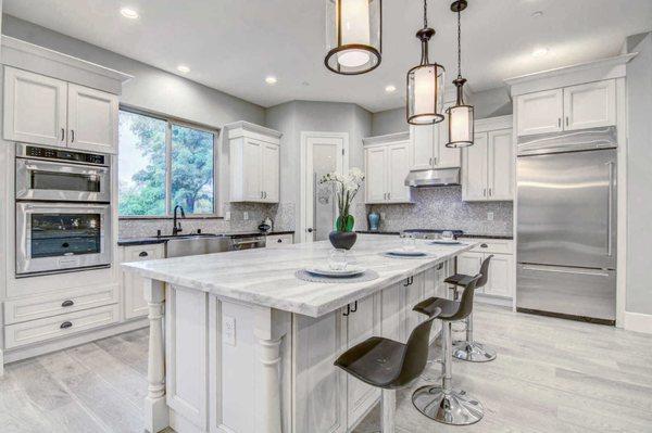 Kitchen Remodeling by Solid Construction & Design. Beautiful kitchen island with new quartzite countertops, new kitchen cabinetry, etc