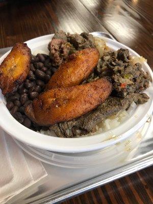 Rice, beans, pepper steak and maduros.