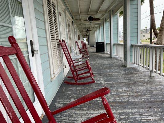 Relaxing morning enjoying coffee  in the rocking chairs on the quiet Tarpon Inn porch watching the world  go by in golf carts .