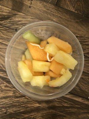 Fruit cup with random pieces of cheese in it. Makes you wonder how clean they keep their kitchen surfaces.