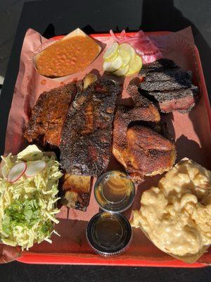 From left to right: mustard slaw, pork ribs, beef ribs, Puerto Rican beans, chicken, beef cheeks & Mac & cheese