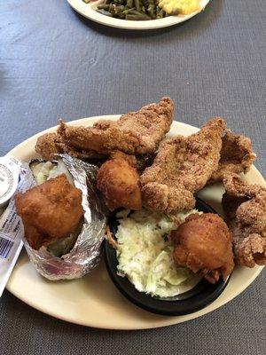 Large catfish plate with slaw, baked potato and hush puppies.