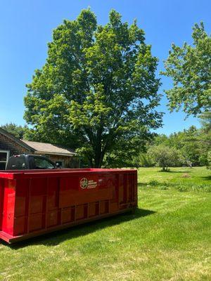 Temporary dumpster in yard of homeowner.