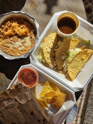 Chicken tacos rice and beans.