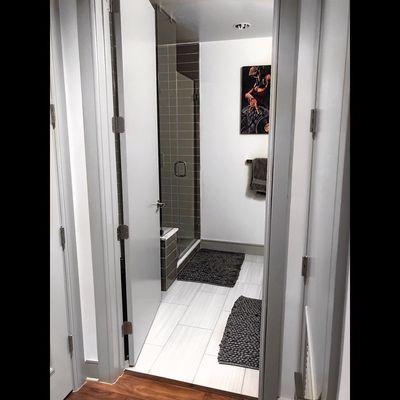 Incredible floor to ceiling GLASS showers with a bench and big bathrooms for a studio unit!